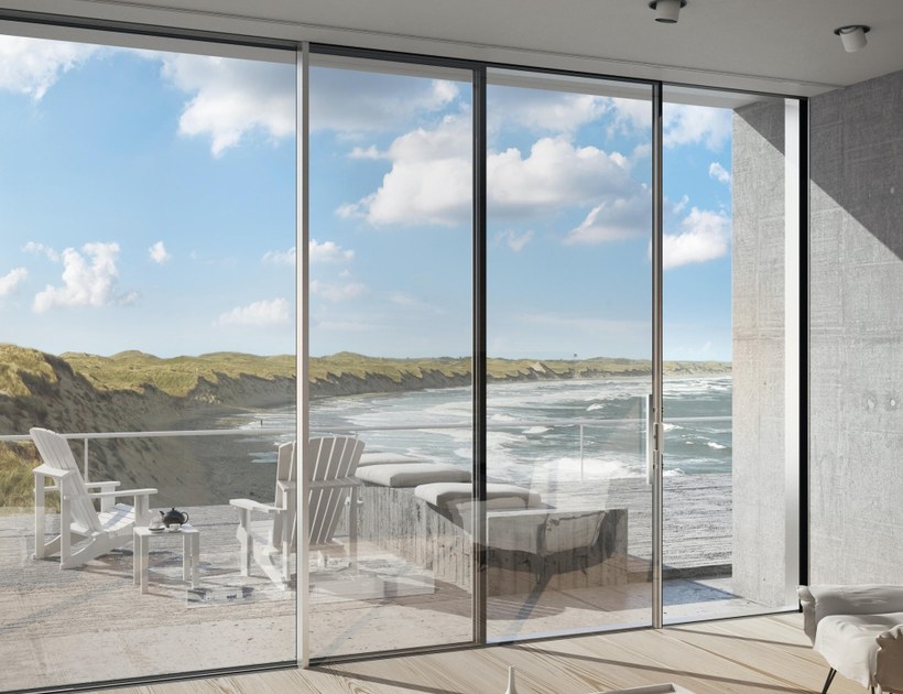 PRM-121 Series aluminum sliding door with coastal beach view through full-height glass panels