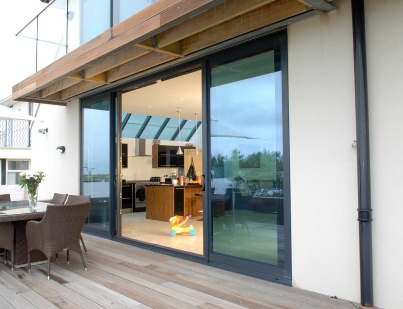 PRM-132 Series aluminum sliding door opening to timber deck with garden view
