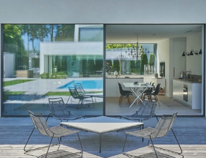 PRM-150 Series aluminum sliding door on modern home exterior with pool and garden view