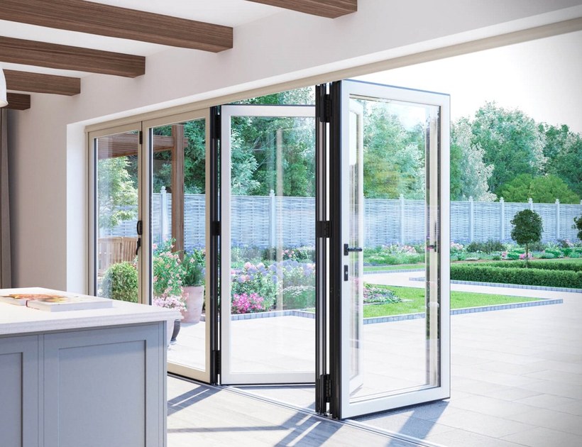 PRM-70 Series aluminum bi-fold door fully open to garden from kitchen
