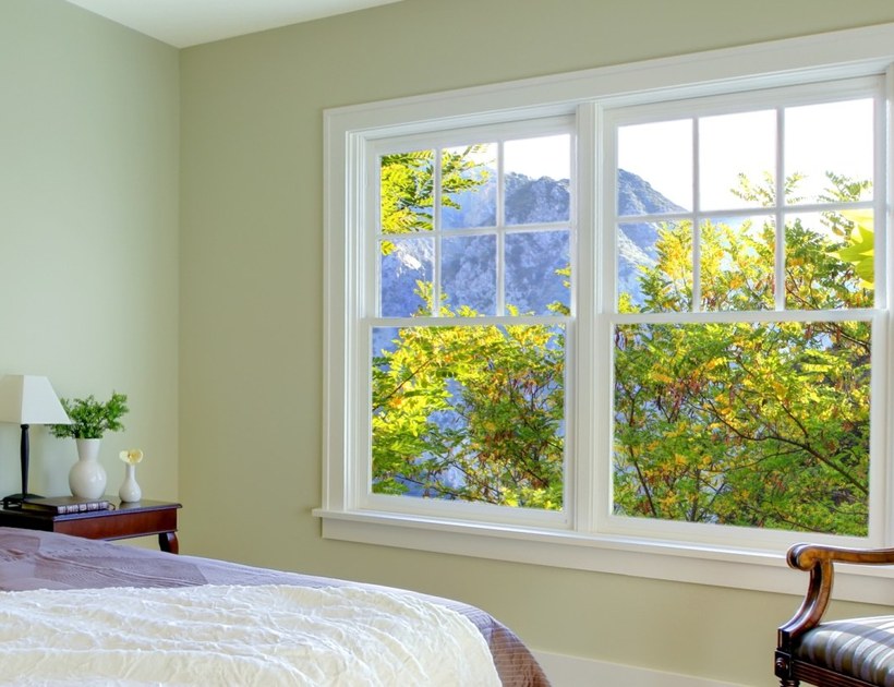 PRM-83 Series aluminum hung window in bright bedroom with garden view