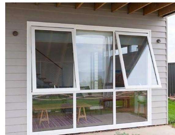 Modern house exterior with multiple uPVC awning panes open