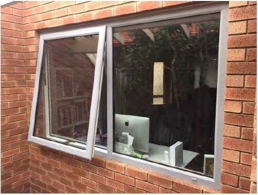 uPVC awning windows on brick exterior, sash tilted outward