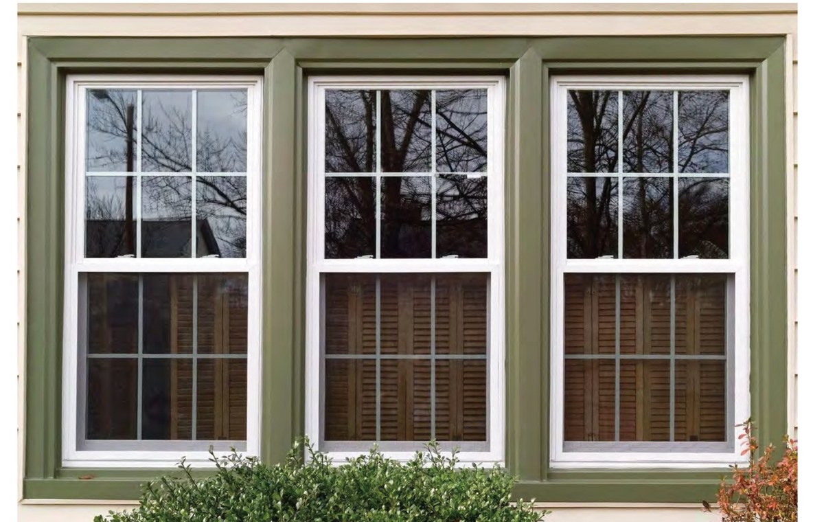 PRM Hung Series uPVC hung windows on house with green trim exterior