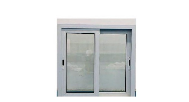 Dark-framed uPVC double sliding window on brick exterior