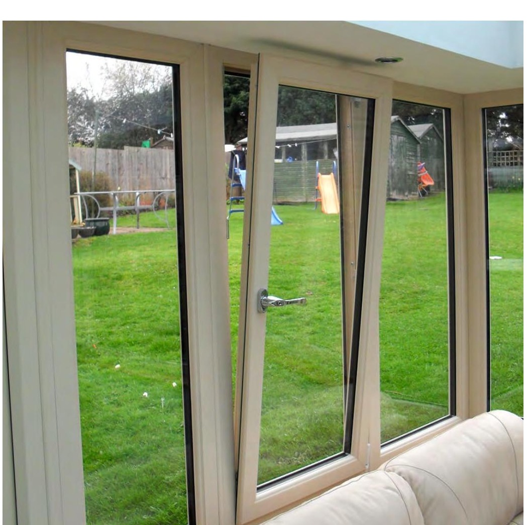 Tilt and turn uPVC windows open in turn mode, interior garden view